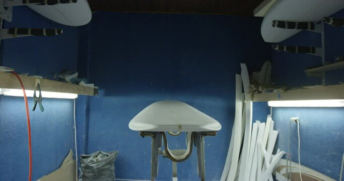 Beautiful blue surfboard shaping workshop
