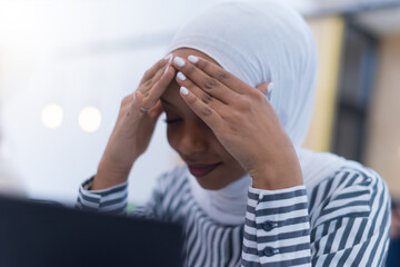 African muslim  businesswoman feeling unwell suffering from headache migraine touching forehead during work, upset black woman employee frustrated by business problem or work stress, head shot