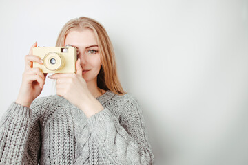 woman taking photos with retro film camera