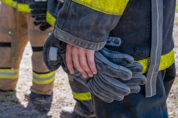 hands of firefighters with gloves on their hands