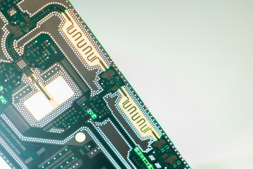 Printed circuit Board on a light background. Gray-green electronic background. Production of...