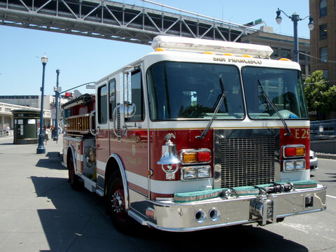 SFFD Red Firetruck Parked On Street With Sun Reflecting In The Window