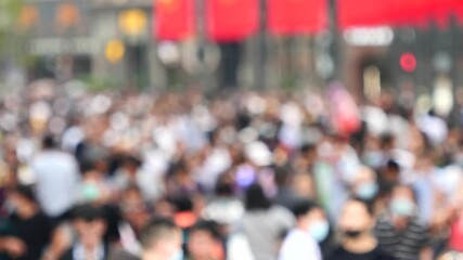 Large crowd of tourist people with medical face masks walking on Nanjing road in Shanghai city, 4K, slow motion footage, blurred defocused view of Concept of coronavirus quarantine.