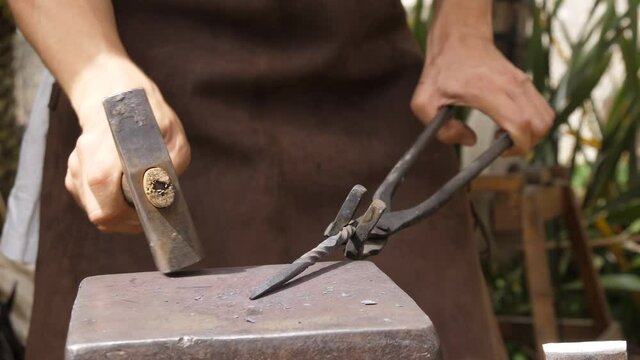 blacksmith hammering metal at medieval forge 4k