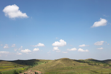 Grassland scenery in northern China under blue sky and white clouds