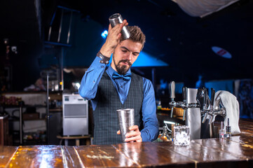 Focused bartending demonstrates the process of making a cocktail at the bar counter
