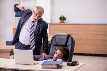 Old boss and young male assistant in the office