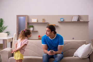 Young man with his daughter at home