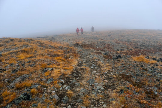 Group of people walking on the ridge on foggy weather. Cathedral Provincial Park. Ocanagan. Keremeos. British Columbia. Canada 