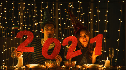 asian couple with numberic letter 2021 at new year and christmas party