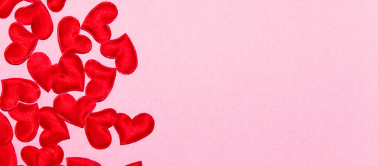 Red hearts on pink background. Valentine's day composition. Top View, flatly, copy space.