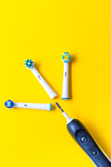 Professional Electric Toothbrush With Separate Attachments On Yellow Background. Vertical Image