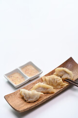 Japanese gyoza or dumplings snack with soy sauce isolated on white.