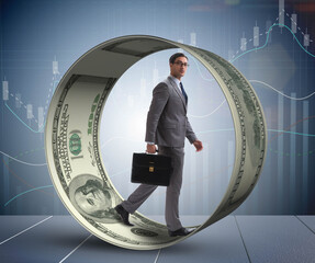 Businessman in hamster wheel chasing dollars