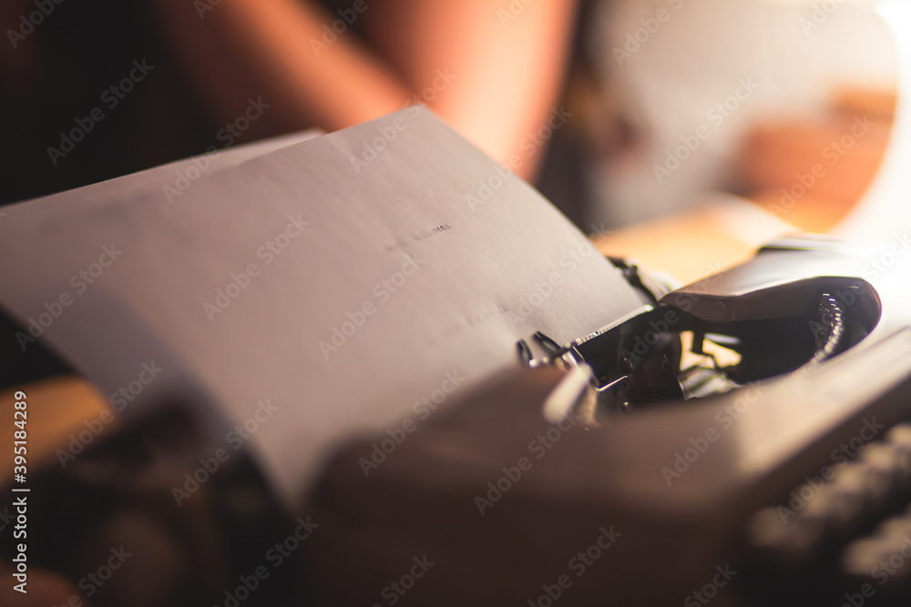 Fototapete process of writing a text letter on a white sheet of paper with old-fashioned typewriter, modern wri