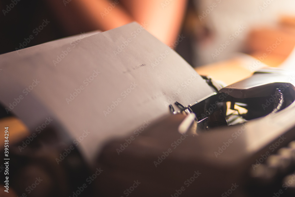 Fototapete process of writing a text letter on a white sheet of paper with old-fashioned typewriter, modern wri