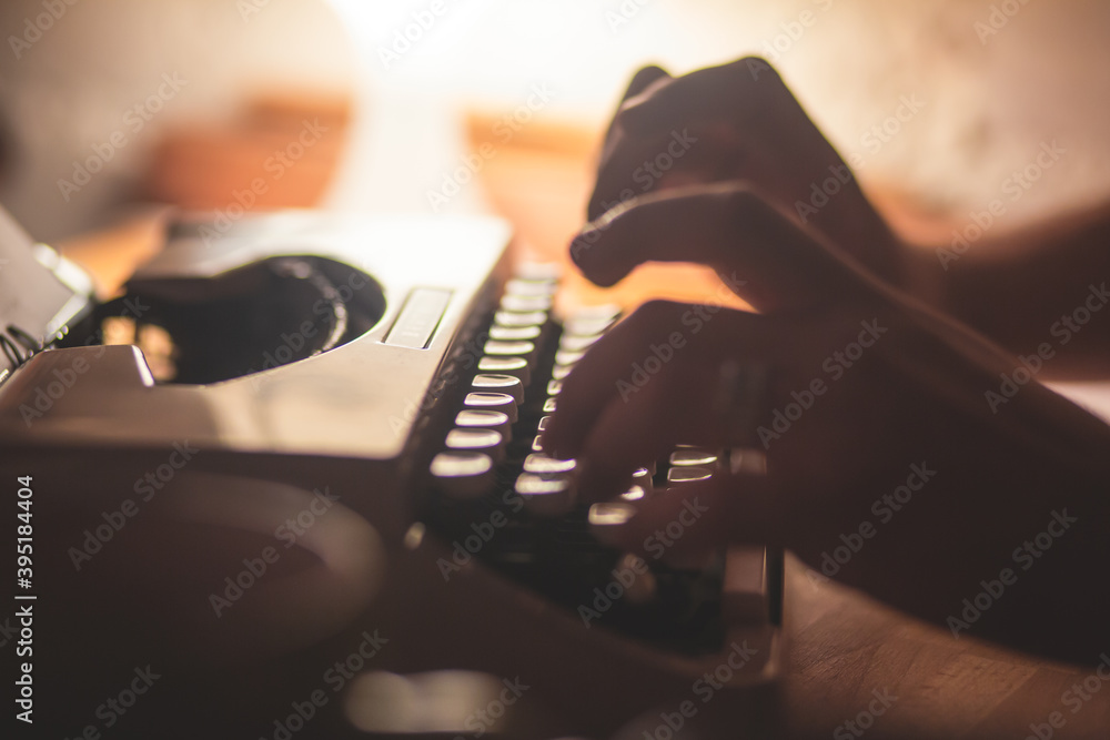 Fototapete process of writing a text letter on a white sheet of paper with old-fashioned typewriter, modern wri