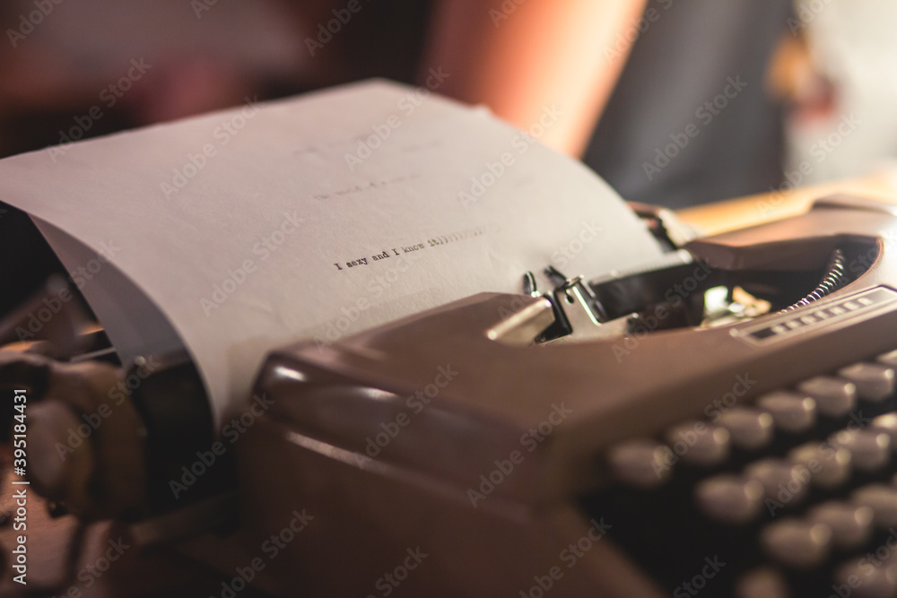 Fototapete process of writing a text letter on a white sheet of paper with old-fashioned typewriter, modern wri