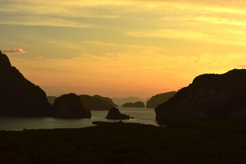 Beautiful scenery and sky with golden yellow white clouds and mountains before sunrise The sunrise from the top of the mountain Overlooking the sea and bay