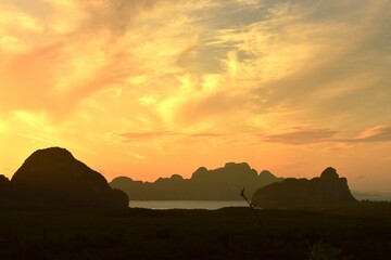 Beautiful scenery and sky with golden yellow white clouds and mountains before sunrise The sunrise from the top of the mountain Overlooking the sea and bay