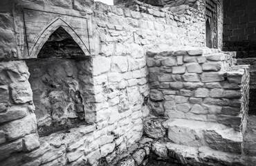 The ruins of the old Arab buildings. Old black and white photo style.