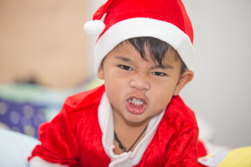 Thai boy in red Santa Claus outfit Smiling happily Happy Christmas Day.