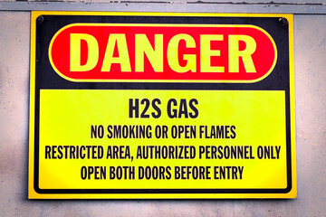 Closeup of a yellow Danger H2S Gas sign