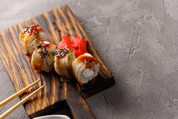 Appetizing rolls on a textured background. Japanese food concept. Close-up. Copy space.