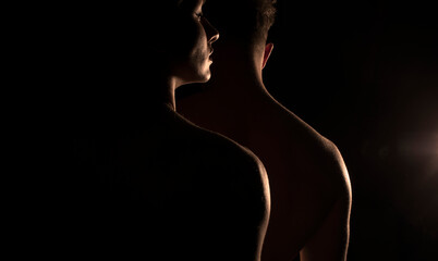 Couple on black background. Couple in love. Sensual. Dark background. Romantic lovers. Photo. Studio. 