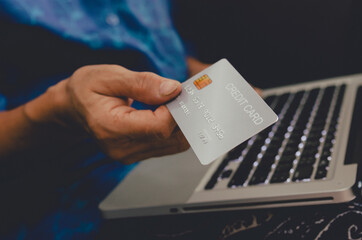 woman holding credit card shopping online