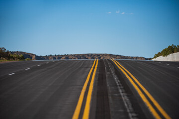 Empty asphalt highway and blue sky. Road panorama on sunny summer day.