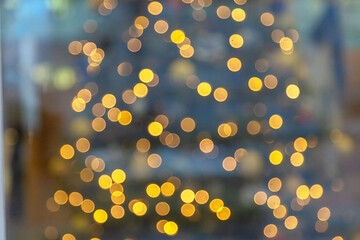 Defocused image. Christmas tree lights on the Christmas tree. The concept of congratulations and meeting the new year