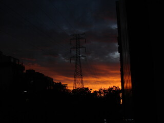 Sunset sky behind powergrid tower