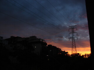 Sunset sky behind powergrid tower