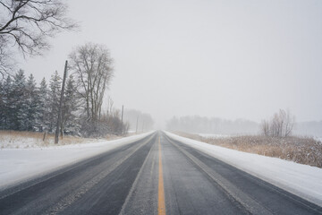 Fototapeta na wymiar Rural Winter Roadway during Snowstorm