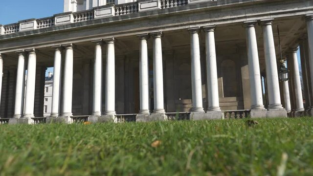 A low angle view an old building with columns.