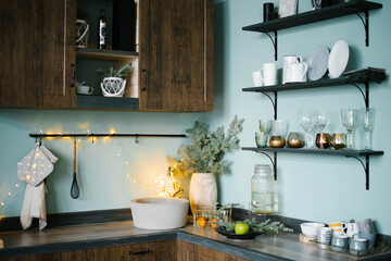 Festively decorated wooden kitchen with blue walls in Scandinavian style