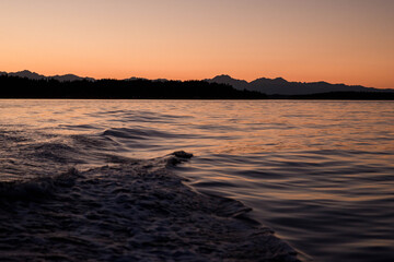 Boating Wave on the Puget Sound overlooking the Olympic National Park Mountains at Sunset