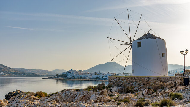 Panorama morning view of the gulf  of Parikia with a wind mill and the traditional white houses as background in  Paros island, Greece.