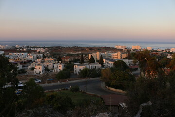 Fototapeta na wymiar view of the city at sunset from the top of the Church of St. Elias Cyprus Protaras