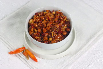 Sambal balado teri kacang is fried anchovy and peanuts with hot and spicy chili sauce. An Indonesian traditional food.