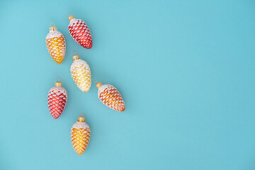 Christmas toys colorful cones on blue background. Copy space. Holiday christmas concept.