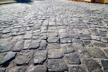 Background with stone blocks in the walkway in city.