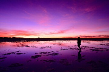 Fototapeta premium A woman walking in Uyuni salt lake 