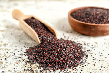 Bowl and scoop with healthy quinoa on light background