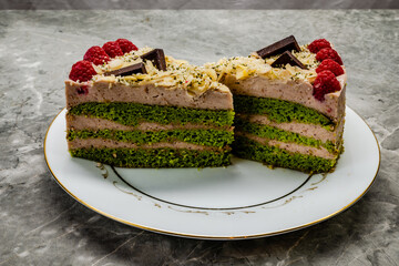 Homemade spinach cake decorated with raspberries and chocolate