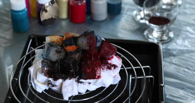 Woman applying ice dye technique to t shirt
