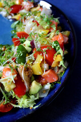 Fresh vegetable salad on a blue background