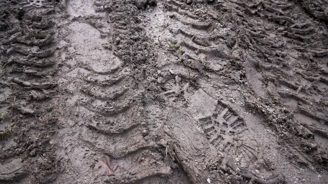 Footprint and traces of an off-road car tires in the mud