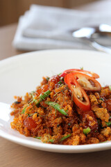 Pad Prik Khing Pla Duk Fu - Crispy fried catfish crumb with spicy and sweet curry paste, kaffir lime leaves and chili sliced. Thai traditional home cuisine